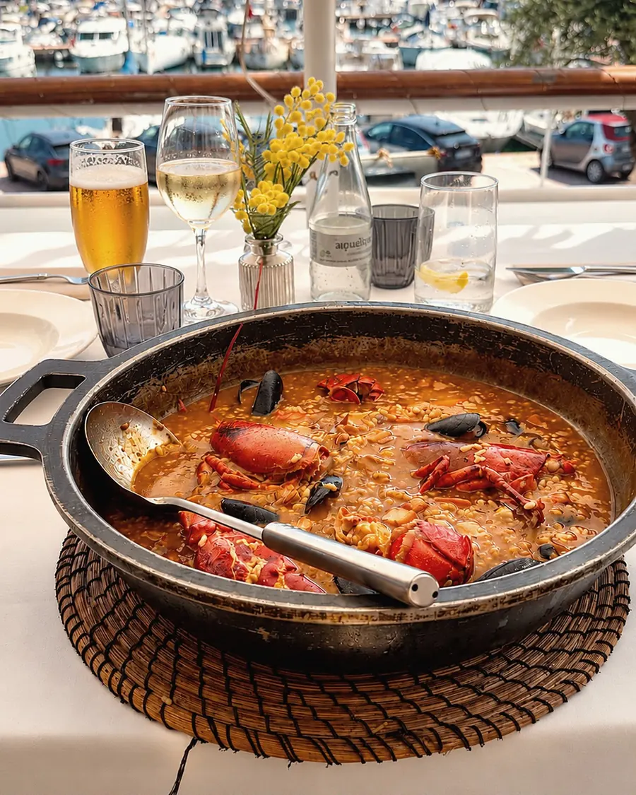Soupy lobster rice with mussels, overlooking the marina